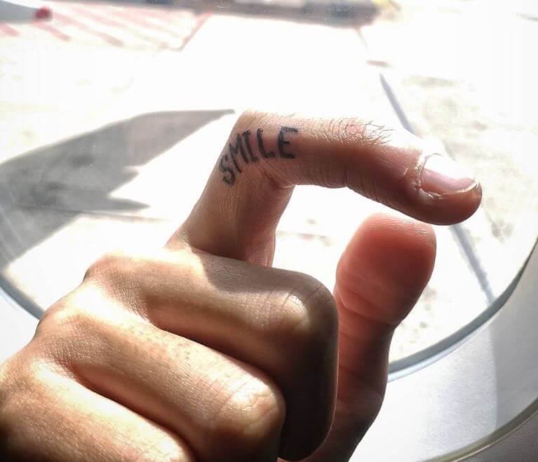 Small Smile Tattoos For Men On Finger