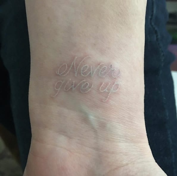 Never Give Up White Ink Tattoo by Caitlin Finney 
