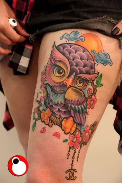 colorful owl tattoo on thigh